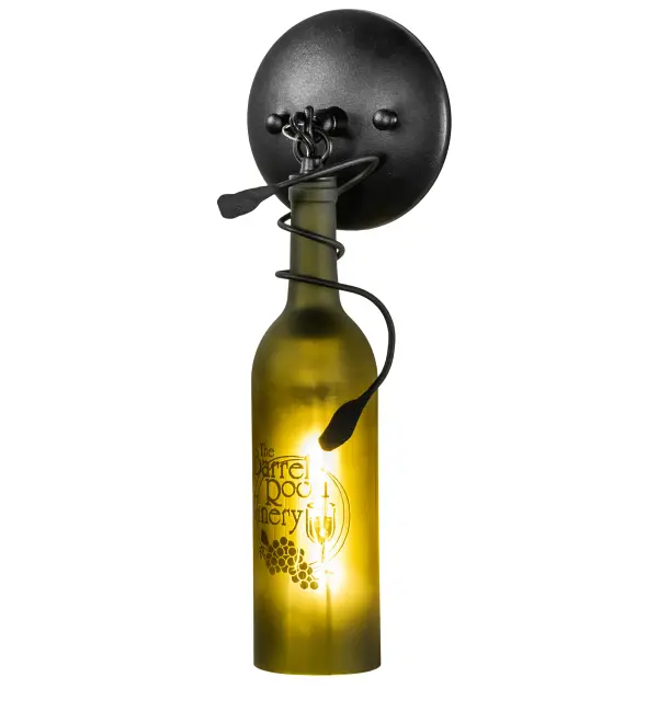 Hand-etched with The Barrel Room Winery Room; this personalized Wine Bottle Wall Sconce does so much more than deliver light; it adds personality and pizzazz. A Green bottle features the hand-etched logo and grape design and is embraced with vine-like accents and hardware featured in a Textured Black finish. This rich-looking Tuscan Vineyard Personalized Wine Bottle Wall Sconce is included in our American-made; American-designed; handcrafted Wine Bottle Lighting Collection. The fixture is manufactured in Yorkville; New York. UL and cUL listed for dry and damp locations. Take your finest bottle of wine; and Meyda will transform it into an everlasting personalized fixture of light. Contact us for more information on personalized and custom wine bottle lighting fixtures and lamps. The fixture can be custom-designed with your name; company logo; or any other message. You can also create custom lighting with beer bottles; mason jars; milk bottles; and other glass containers and vessels by contacting us!