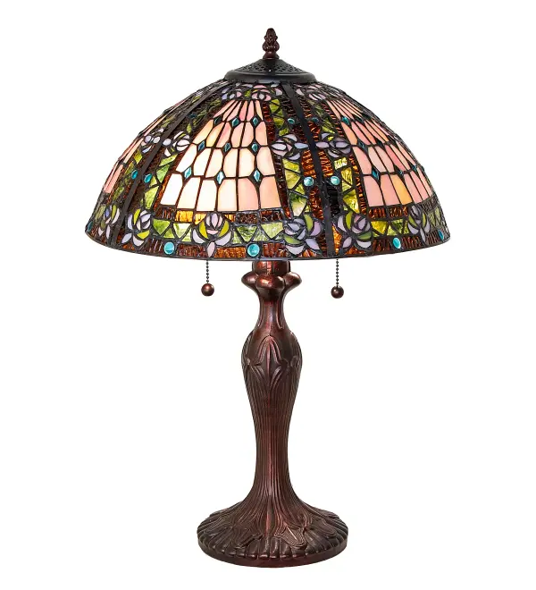 A Meyda Tiffany original design; the Fleur-de-Lis Lamp features an intricate design of Blue stylized tri-petaled irises and matching glass jewels against bands of Twilight and Beige. Reminiscent of castle and cathedral glass; the Fleur-de-lis pattern holds a prominent place in European Heraldry. The lamp base; hand finished in Mahogany Bronze; embraces a stained glass shade which is hand crafted utilizing the copperfoil construction process. Custom options available. UL and cUL listed for dry locations.