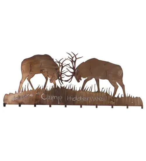 Personalized with the Welcome to Camp HiddenWell" phrase; this handsome Battling Elks Coat Rack captures the natural charm of wildlife beautifully. This striking accessory design combines form and function and features two trophy deer sparring in the woods. The decorative frame is finished in Antique Copper; mounts easily to a wall; and includes ten hooks to hang coats or hats for guests. The Personalized Battling Elks Coat Rack is included in our American-made; American-designed; handcrafted Wildlife Collection and manufactured in Yorkville; New York. It is not available for sale but is shown to demonstrate our custom capabilities. Contact us for more info."