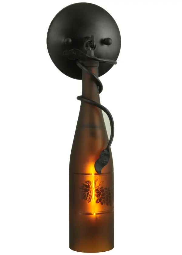 Capture the mood or life of any party with authentic wine bottle lighting. This wall sconce does so much more than deliver light. It adds personality and pizazz to any interior. A hand forged Black vine and leaf coil is designed around the neck of this stunning Amber wine bottle which illuminates and features a stunning etched Grape design. The wall sconce is complemented with handsome hardware featured in a Textured Black finish. Perfect for homes, restaurants, hotels, pubs, nightclubs, wineries, and retailers. Handcrafted by highly skilled artisans in our 180,000 square manufacturing facility in Yorkville, New York. Wine bottle colors, metal finishes and sizes can be customized. UL and cUL listed for dry and damp locations. Collection: Tuscan Vineyard Finish: Textured Black Glass: AmberSandblasted WGrape Design Width: 5.00" Height: 16.00" Length: 5.00" Weight: 3.00 lb Extension from Wall: 5.00" Number of Bulbs: 1 Maximum Wattage: 40.00 W Bulb Type: T6.5 Bulb Base: E17 Material: Metal Country of Origin: USA Safety Listing: Damp Safety Rating: Damp
