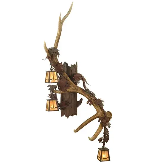 Dramatic wildlife designs come to light. Capture the rustic charm of naturally shed; hand selected Antlers from Elk. No animals are harmed and all Antlers are 100 percent authentic. This wall sconce is adorned with three Beige Iridescent Glass lanterns that project beautiful ambient illumination. This fixture is enhanced with a Rust Wrought Iron finish. This right-sided wall fixture pairs well with the left sconce model 82834. the Handcrafted by highly skilled artisans in our 180;000 square foot manufacturing facility in Yorkville; New York. Shade colors; metal finishes and sconce sizes can be customized as each fixture is made to order. UL and cUL listed for dry and damp locations.