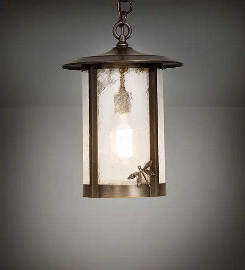 A delicately crafted Dragonfly accents the edge of this handsome Craftsman Signature lantern style pendant. The Solid Brass Pendant; handcrafted at the foothills of the Adirondack Mountains in the USA by highly skilled artisans; is finished in Antique Brass and features Clear Seeded Glass. This fixture is available in custom sizes; colors; and finishes; as well as dimmable energy efficient lamping options such as LED. This ceiling luminaire can be used for both indoor and outdoor lighting applications. The 10-inch wide fixture is UL and cUL listed for dry and wet locations.
