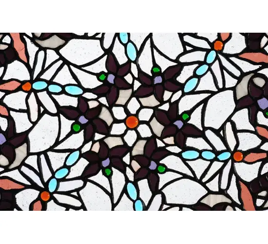 Multicolored glass Dragonflies in Aqua Blue; Emerald Green and Russet Red with Clear Iridescent glass wings swirl playfully among branches and leaves; against a Clear Seedy glass sky background. This enchanting Tiffany inspired stained glass window is trimmed with Emerald Green glass tiled border. The window was created with authentic stained glass using Meyda Tiffany's famous copperfoil construction process. Hanging chains are included. The frame is finished in Black. - alternate view