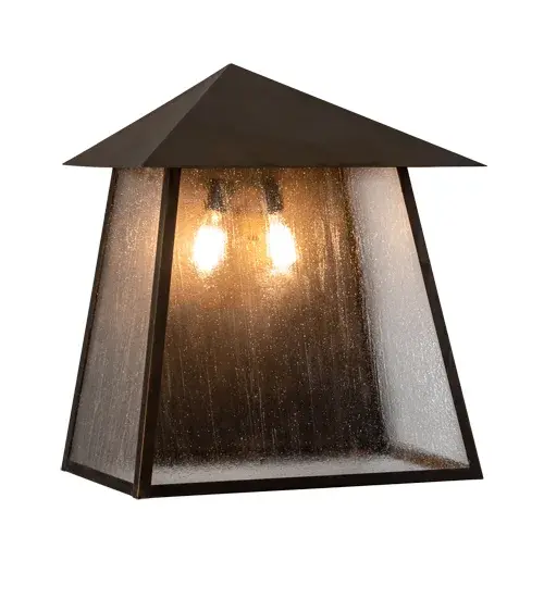 Custom-made from Solid Brass; this Stillwater Wall Sconce is constructed for interior and exterior applications. A stunning Craftsman design statement is captured with a dramatic Mission-style profile. The fixture can be mounted to columns; posts; and decks while providing beautiful ambient lighting in timber homes; modern farmhouses; and other spaces from Traverse City; Michigan; to Lake Tahoe; Nevada; to Lake Geneva; Wisconsin. The Clear Seeded Glass diffuser reveals two Edison-styled lamps and is enhanced with a frame and hardware featured in a Vintage Brass finish. The Stillwater Prime Wall Sconce is included in our American-made; American-designed; handcrafted Craftsman Signature Series and manufactured in Yorkville; New York. UL and cUL listed for dry; damp; and wet locations. Our Build Your Own Craftsman Signature Series features unlimited combinations of styles; functions; sizes; and finishes. Options include lanterns; pier and post mounts; and deck lights crafted of marine-grade materials like brass and copper with timeless living finishes offered to endure harsh climates. - alternate view