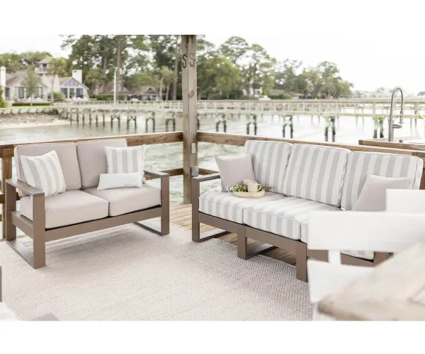 The Nordic Sofa combines modern aesthetics with exceptional durability. Crafted from Marine Grade Poly, it resists UV rays, moisture, and temperature extremes while maintaining its sleek profile and fade-resistant cushions. - alternate view