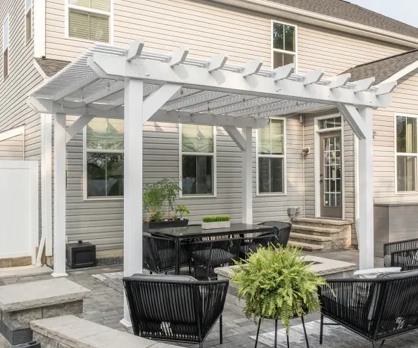 Elevate your outdoor space with our Urbana, a captivating blend of contemporary design and enduring craftsmanship. Immerse yourself in stylish sophistication as you transform your backyard into a haven of relaxation and entertainment. Standard Model Includes: • White vinyl • 6" X 6" posts • Scrolled or classic end caps • Pressure treated wood inserts in posts, beams, and purlins