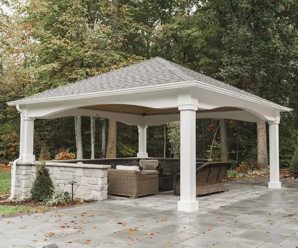 The Victoria Pavilion combines refined traditional design with durable outdoor construction. Features pressure-treated wood wrapped in paintable cellular PVC, exposed pine sheathing, and a classic 6/12 pitch roof for lasting elegance.