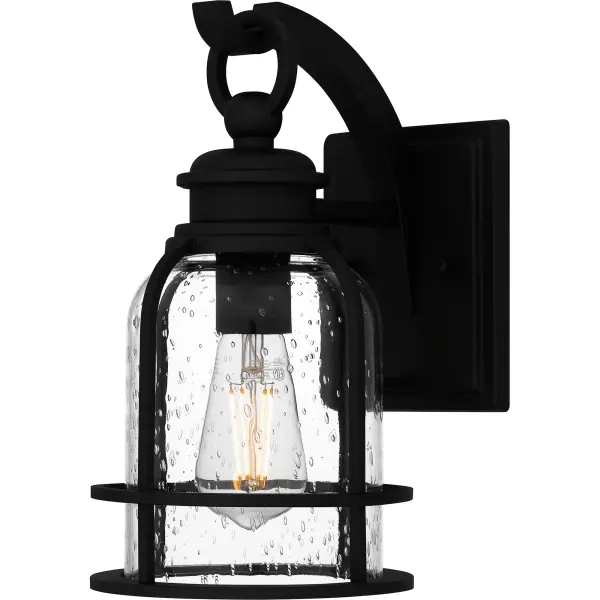 Bowles outdoor lanterns give a nod to both industrial and coastal design. The stately silhouette features clean lines, intricate hook detailing, and exposed bulb sockets - all in a classic Earth Black finish. Clear seedy glass completes the look, offering visual intrigue and style. Bowles is available as a hanging lantern or in multiple sizes of wall light, perfect for illuminating a front porch or landscape.