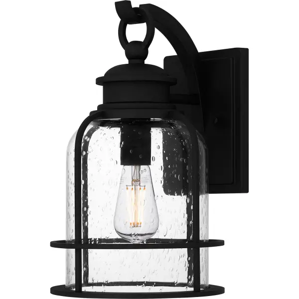 Bowles outdoor lanterns give a nod to both industrial and coastal design. The stately silhouette features clean lines, intricate hook detailing, and exposed bulb sockets - all in a classic Earth Black finish. Clear seedy glass completes the look, offering visual intrigue and style. Bowles is available as a hanging lantern or in multiple sizes of wall light, perfect for illuminating a front porch or landscape.