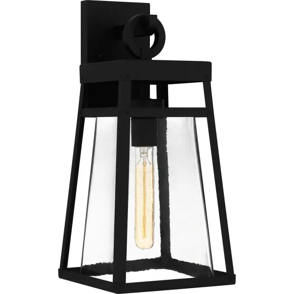 Godfrey is a modern industrial wall lantern designed for sleek exteriors. Its gently tapered frame and matte black finish add to the collection's versatility, while a clear rain glass shade showcases the natural beauty of the light. With subtle industrial details, Godfrey is the perfect style choice next to a front door or as a porch light. As part of our Coastal Armour collection, this product is durable, marine grade, and comes with a 5-year limited warranty.