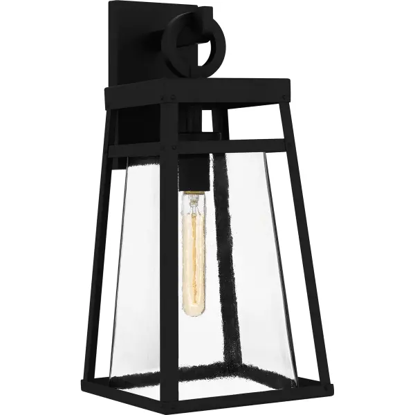Godfrey is a modern industrial wall lantern designed for sleek exteriors. Its gently tapered frame and matte black finish add to the collection's versatility, while a clear rain glass shade showcases the natural beauty of the light. With subtle industrial details, Godfrey is the perfect style choice next to a front door or as a porch light. As part of our Coastal Armour collection, this product is durable, marine grade, and comes with a 5-year limited warranty.