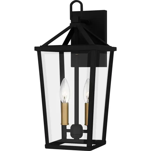 Hull is a traditional outdoor lantern collection designed for sleek exteriors. The tapered frame is finished in matte black and accented beautifully with gold candle sleeves for a hint of luster and industrial style. Clear beveled glass panels complete the look and showcase the natural beauty of the light. Hull is available as a complete collection - round out your home's exterior with a hanging lantern, wall lanterns, or a post lantern.