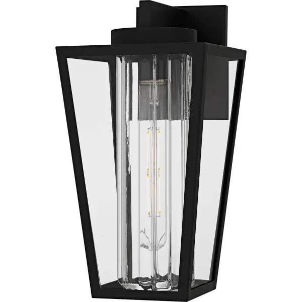 The Jett outdoor lantern collection incorporates transitional style with classic elements, making it a versatile choice for a variety of exteriors.  The stately silhouette features clean lines and a unique center glass column, all finished in a classic matte black.  Clear glass completes the look, offering a balance of visual intrigue and timeless style. Jett is available as a hanging lantern or in multiple sizes of wall light, perfect for flanking doorways, illuminating walkways, or accenting any outdoor space.