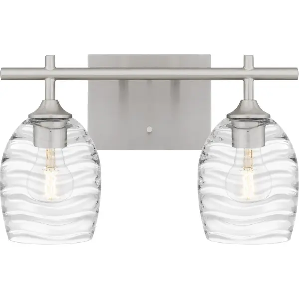 Clear optic glass shades feature a rippling, wavelike pattern that evokes serene movement in the Lucy bath light. Clean lines and your choice of matte black or brushed nickel finish complete the look, making Lucy a perfect complement to transitional or coastal inspired bathroom vanity settings. Install with shades facing up or down - whichever best suits your preference. Collection: Lucy Rooms: Bathroom Finish: Brushed Nickel Glass: Clear Optic Glass Width: 15.00" Height: 9.25" Length: 6.50" Weight: 4.65 lb Extension from Wall: 6.50" Wire: 6" Canopy: 6.500"x5.000" Number of Bulbs: 2 Maximum Wattage: 100.00 W Bulb Type: E26 Bulb Base: Medium Voltage: 120.00 V Material: Steel Safety Listing: ETL Spec Sheet Instructions