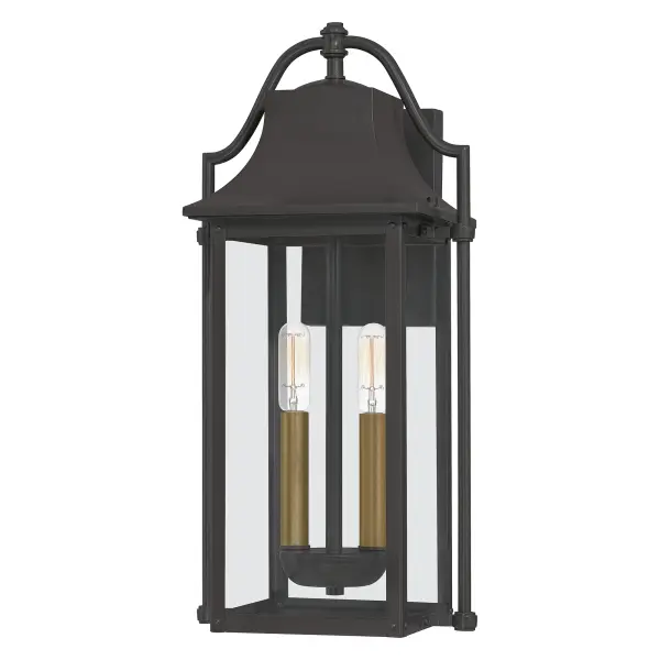 Bring a welcoming glow to your home's entrance with the Manning collection. This traditional style lantern is finished in Western Bronze and gives off an old gaslight feel. The clear glass panels allow for an unobstructed view of the light's interior which features  Weathered Brass candsleeves for a unique, dual-tone look.
