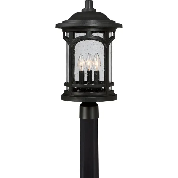 The Marblehead post lantern combines masculine traditional styling with modern weather-resistant materials. Clear seedy glass and arched metal details create a window-like appearance that adds architectural interest to outdoor spaces.