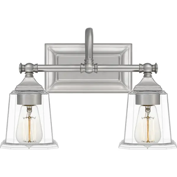 The Nicholas collection gives a solid nod to mid century style. The streamlined silhouette is finished in Brushed Nickel, Polished Chrome, or Earth Black to compliment a variety of home styles. The tapered square glass shades gives this design an edge and it is complemented beautifully by the rectangular backplate. All bath fixtures can be mounted as uplights or downlights and are offered in several sizes. Collection: Nicholas Rooms: Bathroom Finish: Brushed Nickel Glass: Clear Glass Width: 15.00" Height: 10.00" Length: 7.00" Weight: 3.80 lb Extension from Wall: 7.00" Wire: 6" Canopy: 8.000"x4.500" Number of Bulbs: 2 Maximum Wattage: 100.00 W Bulb Type: E26 Bulb Base: Medium Voltage: 120.00 V Material: Steel Country of Origin: China Safety Listing: ETL Safety Rating: ETL Switch: None Connection: Hardwire Spec Sheet Instructions Parts Diagram