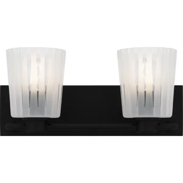 The Gray lighting collection offers a striking blend of transitional design and classic charm. The clear glass shades are characterized by distinct vertical ribs that create an intriguing interplay of light and shadow. Etched patterns in between the ribs further the visual effect of the unique shades. The matte black finish of the metal frame provides a sleek contrast to the textured glass. Gray is available as a mini pendant light, semi-flush mount, or in various sizes of bath light.