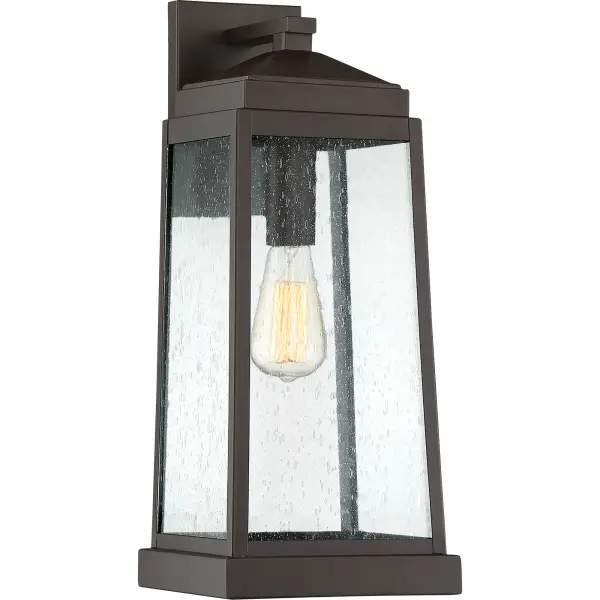 The Ravenel's classic silhouette features an updated design that combines understated elegance and quality craftsmanship. A gently tapered frame in Western bronze features generous panels of seedy glass that diffuse the soft glow of the light inside. Vintage bulbs provide additional warmth to this already inviting collection.