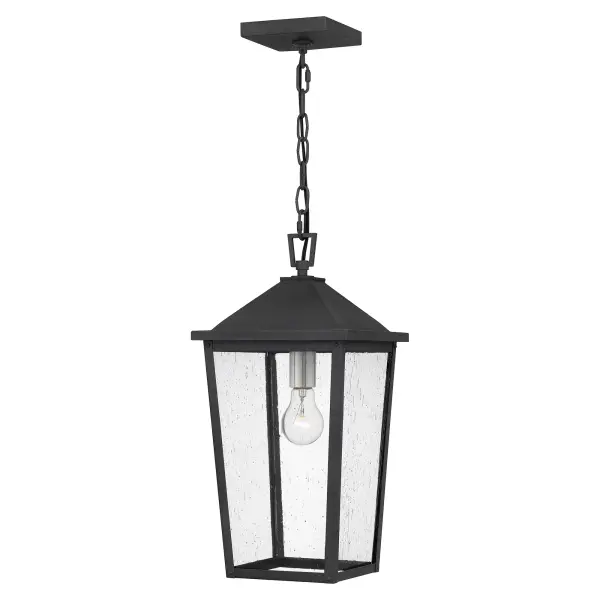 Clear seeded glass gives Stoneleigh a touch of whimsy. In a mottled black finish, this pendant design is otherwise stately and handsome. Suspend it within a portico to welcome guests in refined fashion.