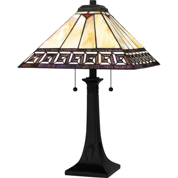 The Edith table lamp delivers on both style and function. The classic Arts and Crafts design features a matte black finish and multicolored glass shade. The handcrafted shade is made of hand assembled Tiffany glass in shades of cream and warm honey amber with a geometric border of rich, purple jewel tones. Illuminate your living room, add style to a home office, or cozy up in your bedroom for some reading.