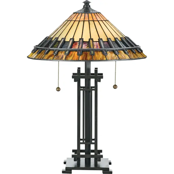 The lamp pays homage to the enduring Arts and Crafts style  which is typified by straight lines forming squares and rectangles.  The handcrafted shade honors the tradition of quality and attention to detail  and the coordinating base has an authentic bronze patina.Glass color in Tiffany lighting products vary in color.  No two pieces are identical.