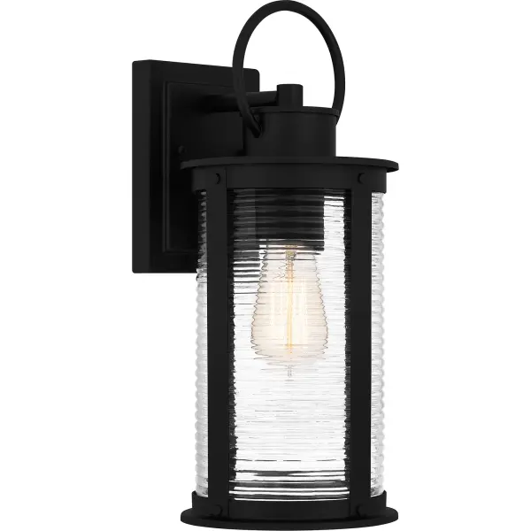Tilmore outdoor lanterns are the perfect companion to coastal-inspired exteriors. The sturdy matte black frame is accentuated by clear ribbed glass for a classic look, designed to withstand the elements in style. Available as a hanging lantern, post lantern, and various sizes of wall lantern, Tilmore is an easy way to illuminate a front porch or landscape.