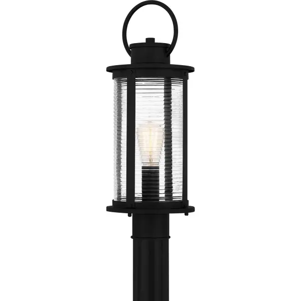 The Tilmore post lantern combines timeless coastal design with practical outdoor durability. Its matte black aluminum frame and clear ribbed glass create visual interest while standing up to the elements.