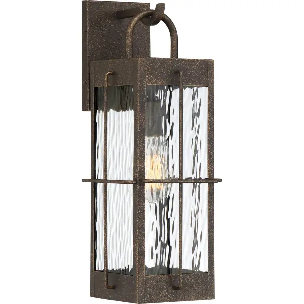 Rippled glass evokes the movement and serenity of water in Ward, a collection of wall and post lanterns ideal for coastal landscapes. The hanging wall lanterns bring a modern farmhouse design while posts, installed at regular interviews, welcome visitors with pomp and circumstance. A gilded bronze finish is equal parts classic and rustic.