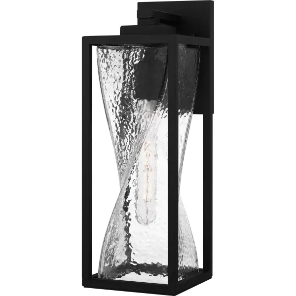 Zarah outdoor wall lanterns are the perfect companion to transitional style exteriors. The sturdy matte black frame is accentuated by clear hammered glass, featuring a fun twist design. Designed to withstand the elements in style, Zarah is an easy way to add illumination to a front porch or landscape.