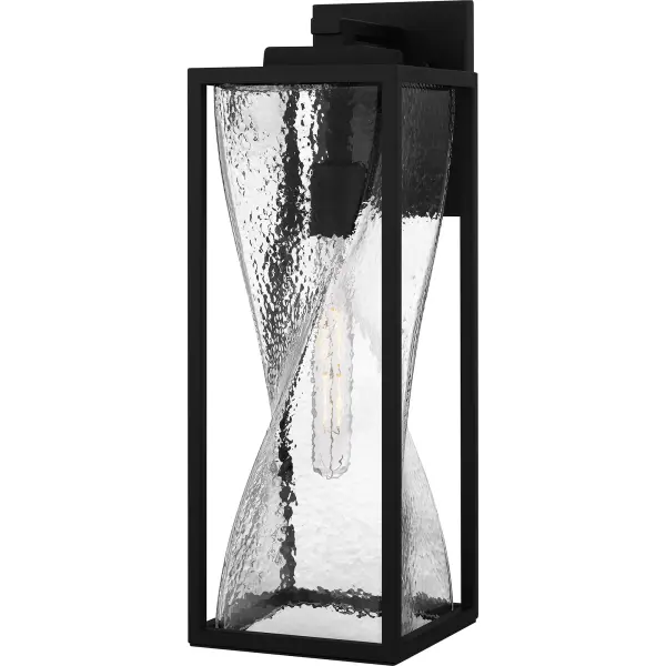 Zarah outdoor wall lanterns are the perfect companion to transitional style exteriors. The sturdy matte black frame is accentuated by clear hammered glass, featuring a fun twist design. Designed to withstand the elements in style, Zarah is an easy way to add illumination to a front porch or landscape.