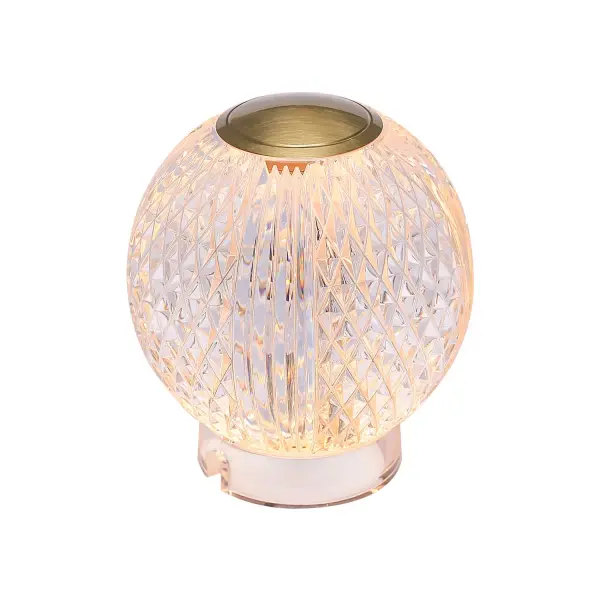 Introducing the latest masterpiece in our bestselling Marni collection - the Marni portable lamp. This stunning lamp marries modern elegance with timeless beauty, elevating any space it graces. With two available sizes and two exquisite finishes, Vintage Brass and Polished Nickel, you can customize your decor effortlessly. Experience the convenience of easy tap on/off and dimming, all powered by a rechargeable battery, making it a truly portable and practical addition to your home. Illuminate your life with the Marni portable lamp, where sophistication meets functionality. Collection: Marni Designer: Ryan Pauly Finish: Natural Brass Glass: Clear Carved Acrylic Notes: LI-Battery Width: 4.38" Height: 4.25" Length: 4.38" Wire: Black Charger Canopy: D2.625" x H0.75" Charging Base Only Maximum Wattage: 2.00 W Bulb Type: LED Light Source: LED Light Output: 200.00 lm Delivered Lumens: 125.00 lm Color Temperature: 3000 K CRI: 90 Rated Average Life: 50,000 Material: Steel + Acrylic Country of Origin: China Safety Listing: ETL Safety Rating: Damp LED Spec Sheet Instructions