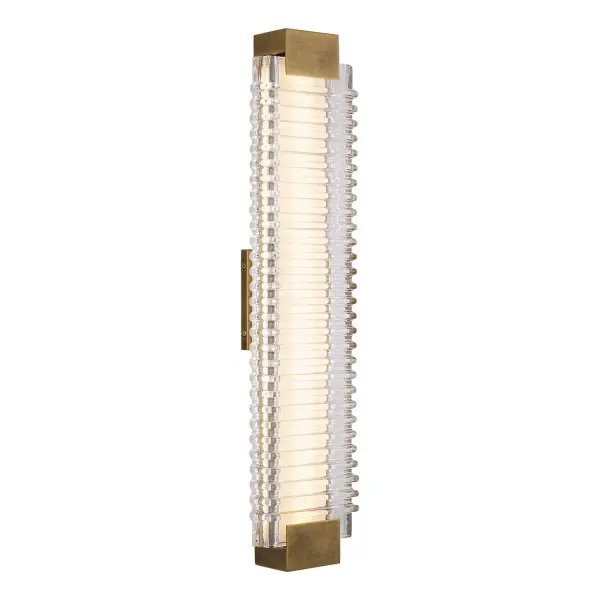 Indulge in the ethereal allure of Alai, where each piece echoes the gentle ripple of ocean waves with its ribbed glass design. Illuminate your space with a timeless blend of modern elegance and classic charm, as warm integrated LED light breathes life into your space. Collection: Alai Designer: Alan Pepin Finish: Vintage Brass/Ribbed Glass Glass: Clear Ribbed Glass Width: 5.63" Height: 25.00" Length: 5.63" Extension from Wall: 2.75" Maximum Wattage: 29.00 W Bulb Type: Module Bulb Base: AC Light Source: LED Light Output: 2380.00 lm Delivered Lumens: 773.00 lm Color Temperature: 2700 K CRI: 90 Rated Average Life: 50,000 Voltage: 120.00 V Material: Steel + Glass Country of Origin: China Safety Listing: ETL Safety Rating: Damp ADA Title 24 LED Spec Sheet Instructions