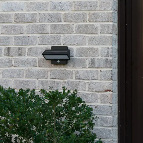 This architectural solar wall light combines eco-friendly operation with motion-sensing security. Cast aluminum construction ensures durability, while dual color temperature and adjustable brightness settings provide versatile outdoor illumination. - alternate view