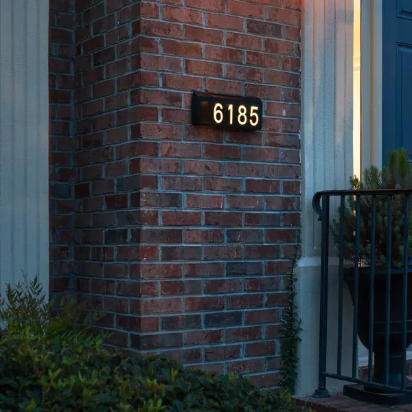 Eco-friendly solar address light that automatically illuminates your home number from dusk to dawn. Features dual color temperature LEDs, weather-resistant resin construction, and versatile ground stake or wall mount installation. - alternate view