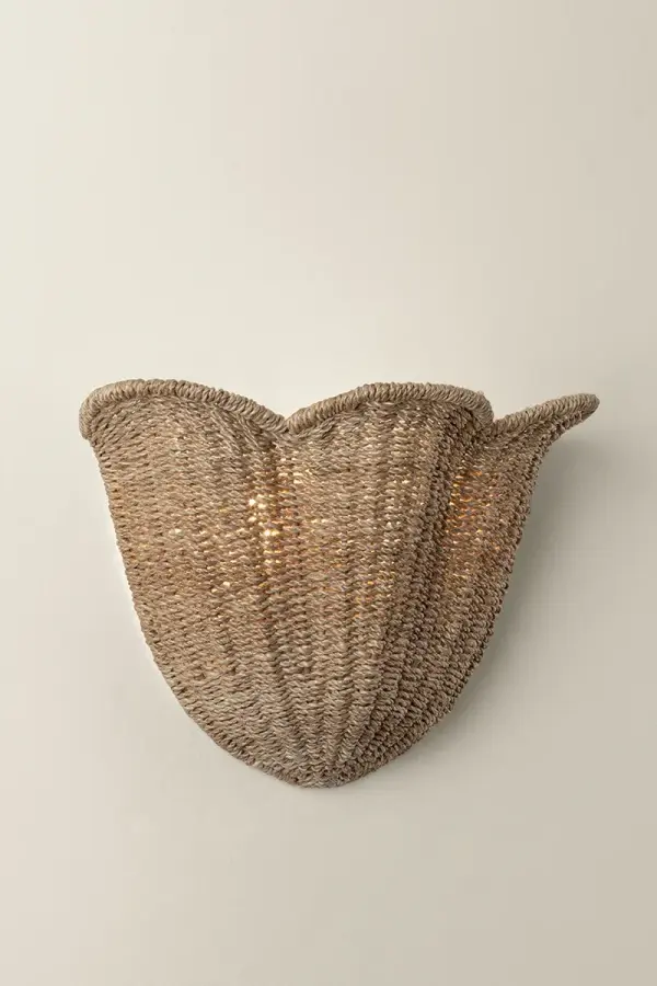 The Ardonia family pairs two trending design elements, scallops and naturals. Woven tightly from abaca fibers, the upward-facing tapered bowl shade has a petal-shaped edge to resemble a flower in bloom. The Vintage Gold Leaf frame is accented by an abaca-wrapped rod suspension, which points to the skill of the artisan craftsmen. Available as a 2-light sconce and a 4 or 6-light chandelier, this family is a breath of fresh air. Due to the one-of-a-kind nature of the medium, exact colors and patterns may vary slightly from the image shown. Collection: Ardonia Designer: Hudson Valley Lighting Finish: Vintage Gold Leaf Glass: Abaca Width: 14.00" Height: 10.00" Weight: 7.70 lb Extension from Wall: 6.50" Canopy: 4.25"x4.25" Number of Bulbs: 2 Maximum Wattage: 10.00 W Bulb Type: B11 Bulb Base: E12 Candelabra Voltage: 120.00 V Material: Natural Woven Country of Origin: PH Safety Listing: UL/cUL Safety Rating: Damp Manufacturer Warranty: 1 Year Limited Manufacturer Spec Sheet Instructions