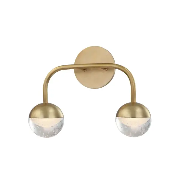 The dome, the arch, the vault—all intrinsically hallowed forms that resonate in the human mind. Our Boca family traces iconic arcs in each direction in a gorgeous contemporary fixture. At either end of each arc are unique spherical glass diffusers. Metal on the top half, layered on the bottom, each one contains a one-of-a-kind assortment of bubbles. Clear on the outside, etched on the inside, these orbs provide dimension and depth to the LED light spilling out from within them. Collection: Boca Designer: Hudson Valley Lighting Finish: Aged Brass Glass: Clear Frosted Width: 13.00" Height: 9.50" Weight: 5.00 lb Extension from Wall: 5.00" Wire: 12`` Canopy: 4.75"x0.5" Number of Bulbs: 2 Maximum Wattage: 4.00 W Bulb Type: LED Bulb Base: Integrated Light Source: LED Light Output: 480.00 lm Color Temperature: 3000 K CRI: 90 Voltage: 120.00 V Material: Steel Country of Origin: CN Safety Listing: UL/cUL Safety Rating: Damp LED Manufacturer Warranty: 1 Year Limited Manufacturer Spec Sheet Instructions Parts Diagram