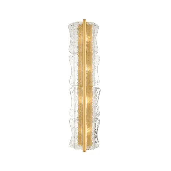 The Fosterdale sconce draws on an anthropomorphic design language reminiscent of Elsa Peretti. Stacked clear piastra glass shades curve into the wall like ice melting around the light source. A slender cylindrical tube finished in Aged Brass secures the glass at the center while shielding the candelabra bulbs from direct view. Thoughtfully scaled for bath and powder rooms, Fosterdale can be oriented vertically or horizontally as needed. Available with 1-4 lights. Collection: Fosterdale Designer: Hudson Valley Lighting Finish: Aged Brass Glass: Clear Optic Width: 8.25" Height: 36.25" Weight: 17.93 lb Extension from Wall: 4.00" Canopy: 4.25"x34.00" Number of Bulbs: 4 Maximum Wattage: 10.00 W Bulb Type: B11 Bulb Base: E12 Candelabra Voltage: 120.00 V Material: Glass Country of Origin: VN Safety Listing: UL/cUL Safety Rating: Damp ADA Manufacturer Warranty: 1 Year Limited Manufacturer Spec Sheet Instructions