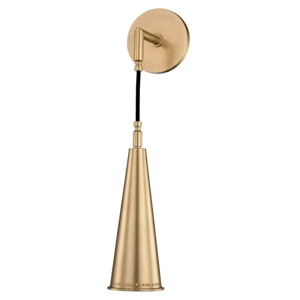 The Alva wall sconce blends mid-century design with industrial details through its perforated metal cone shade and articulating gooseneck arm. The aged brass finish and cast-metal backplate add vintage character while LED compatibility ensures modern efficiency.