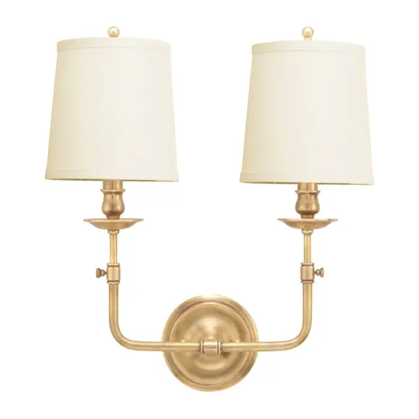The Logan wall sconce combines classic proportions with contemporary clean lines. Its aged brass finish and off-white linen shade create a sophisticated, versatile look that works in both traditional and modern settings.