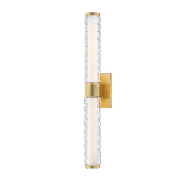 Castor brings modernized Art Deco elegance to bathroom lighting with its distinctive ridged glass tubes that create an icy, contemporary glow. The integrated LED provides efficient, warm illumination while the Aged Brass finish adds sophisticated warmth.