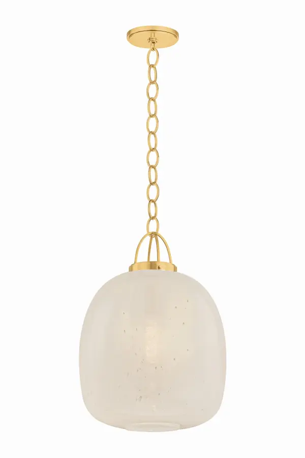 The Enosburg pendant combines soft organic form with distinctive metalwork. Its oblong cloud seedy glass shade creates visual interest through bubbled texture, while the cage-like brass suspension adds architectural detail.