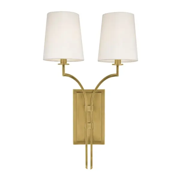The Glenford wall sconce combines classic proportions with contemporary simplicity. Its aged brass finish and faux silk shades create a sophisticated, versatile look that works in both traditional and modern interiors.