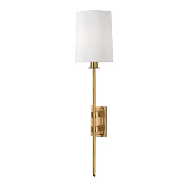 The Fredonia wall sconce combines classic proportions with contemporary simplicity. Its aged brass finish and faux silk shade create warm, diffused light perfect for intimate spaces. Compact profile works in tight hallways.