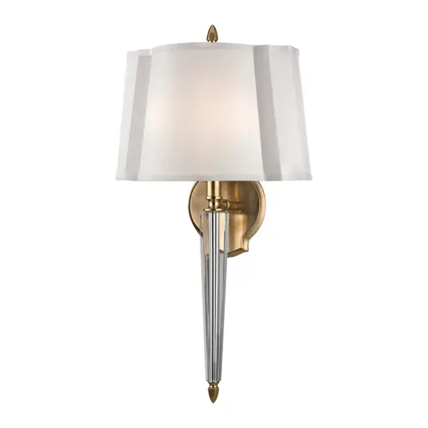 The Oyster Bay wall sconce brings sophisticated coastal charm with its aged brass finish and soft faux silk shades. Perfect for creating ambient lighting in bedrooms and living spaces with a transitional aesthetic.