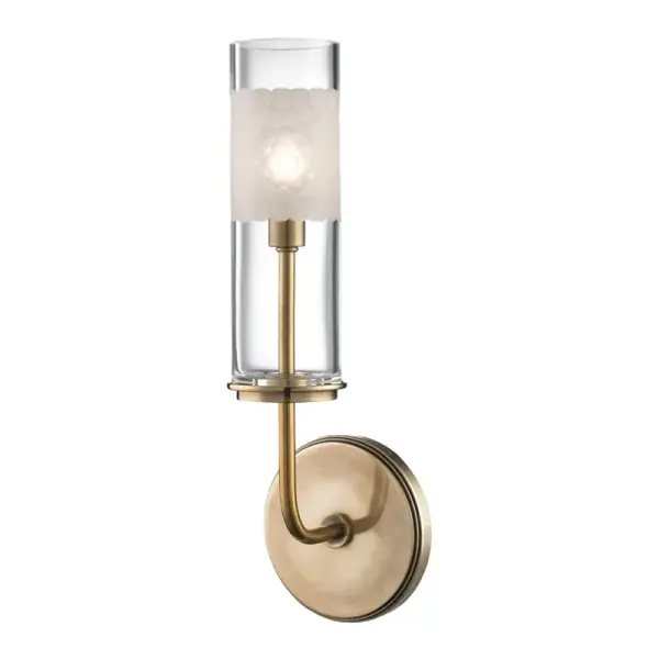 The Wentworth wall sconce beautifully balances form and function with its mouth-blown glass tube featuring a hand-cut honeycomb pattern. The design reveals the inner candlestick structure while softly diffusing light through artisan glasswork.