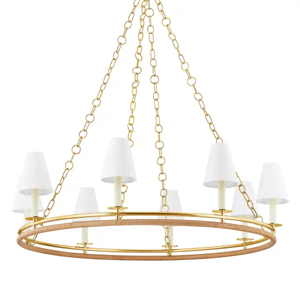 The Swanton chandelier masterfully blends nautical charm with sophisticated design through its distinctive double-ring construction. The interplay of aged brass and natural rattan creates visual interest while maintaining an airy, approachable aesthetic.