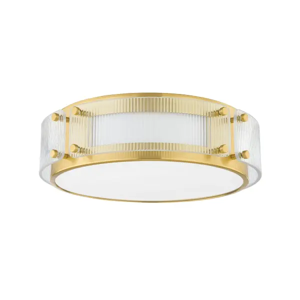 The Clifford flush mount combines traditional craftsmanship with contemporary design through its rectangular brass panels and ribbed glass detailing. Integrated LED technology delivers warm, efficient lighting while the unique construction allows light to escape through side pockets, creating ambient illumination beyond the primary downlight.