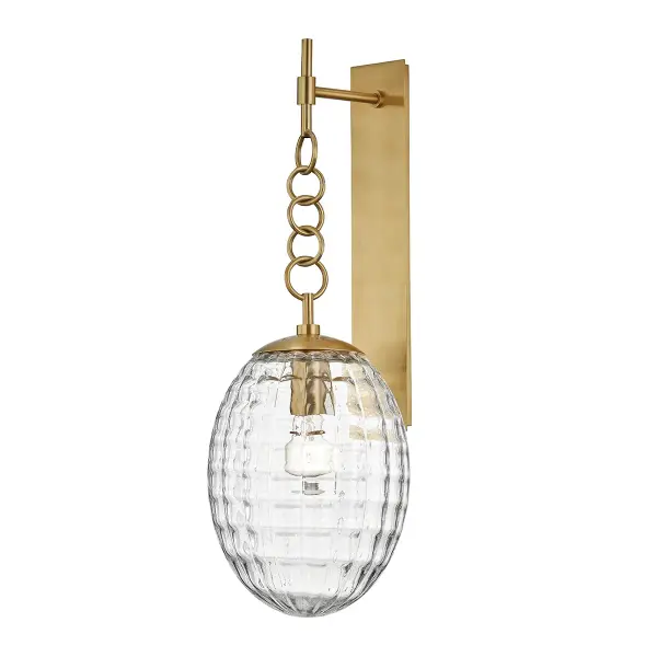 The Venice wall sconce features a distinctive egg-shaped quilted glass diffuser that creates rich textural dimension and visual intrigue. The aged brass finish adds warmth while the billowy glass pattern softly diffuses light.