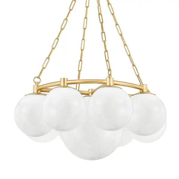 The Thornwood chandelier creates a dramatic focal point with nine cloud glass globes arranged around a central sphere. The wispy, organic glass paired with aged brass detailing delivers both visual impact and warm ambiance.